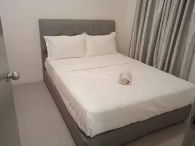 a bed with a towel on top of it at Cahaya Gardens 2 rooms at Golden Hills depan pasar malam in Brinchang