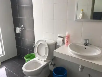 a bathroom with a toilet and a sink at Cahaya Gardens 2 rooms at Golden Hills depan pasar malam in Brinchang