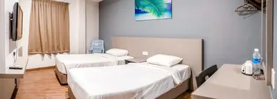 a hospital room with two beds and a table at K West Hotel in Sitiawan