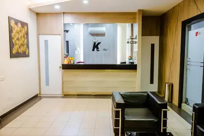 a waiting room with a chair and a mirror at K West Hotel in Sitiawan