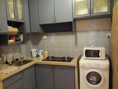 a kitchen with a sink and a stove and a microwave at Fastbook Bendera Home 8 & 10pax in Ayer Itam