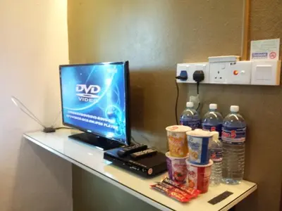 a desk with a laptop computer and drinks on it at Fastbook Bendera Home 8 & 10pax in Ayer Itam