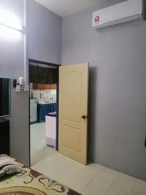 a room with a door open to a kitchen at Syaqisya Homestay in Seri Manjung