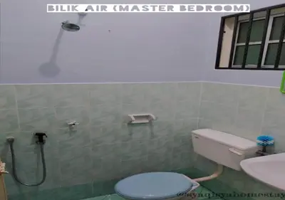 a bathroom with a toilet and a sink and a shower at Syaqisya Homestay in Seri Manjung