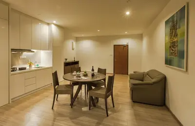 a kitchen and a dining room with a table and chairs at Luxfort 118 Service Suites in George Town