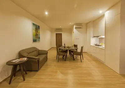 a living room with a couch and a table at Luxfort 118 Service Suites in George Town