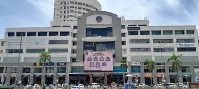 a large building with a sign in front of it at Luxfort 118 Service Suites in George Town
