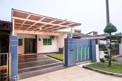 a house with a blue door in the yard at Landed Cozy House Near SPICE, Airport in Kampong Manggis