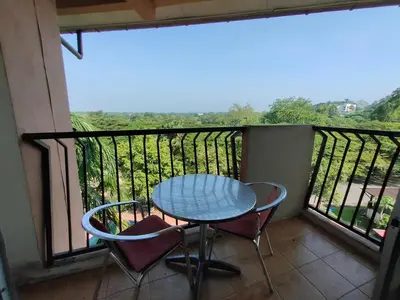 a table and chairs on a balcony with a view at Jana View Condotel MN in Kamunting