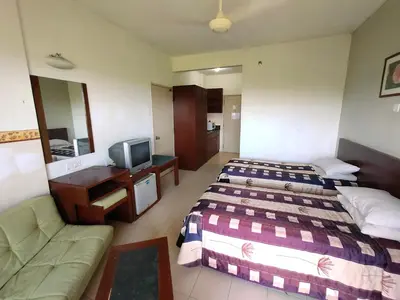 a hotel room with two beds and a television at Jana View Condotel MN in Kamunting