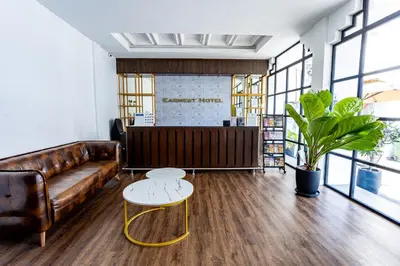 a living room with a leather couch and a table at Earnest Hotel Georgetown in George Town