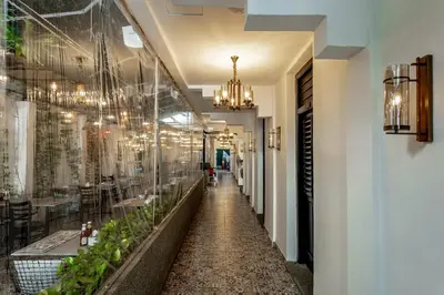 a hallway of a restaurant with chandeliers at Earnest Hotel Georgetown in George Town