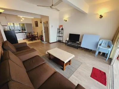 a living room with a couch and a table at Little England B5-2 Fraser Panorama in Bukit Fraser