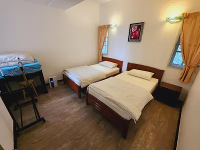 a bedroom with two beds and a window at Little England B5-2 Fraser Panorama in Bukit Fraser