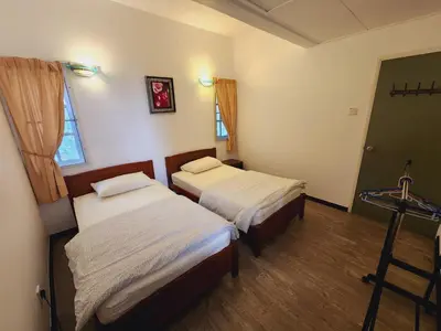 a room with two beds and a window at Little England B5-2 Fraser Panorama in Bukit Fraser