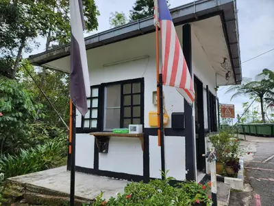 a small house with a flag in front of it at Little England B5-2 Fraser Panorama in Bukit Fraser