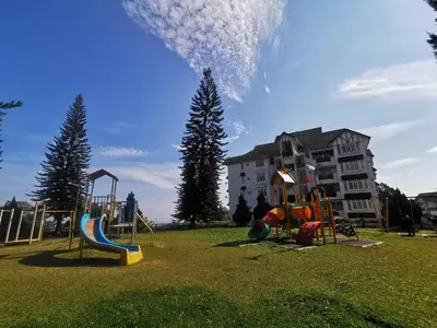 a playground in a park with a building in the background at Little England B5-2 Fraser Panorama in Bukit Fraser