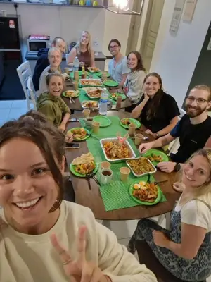 a group of people sitting around a table eating food at A3A Oastel CoLiving in Tanah Rata