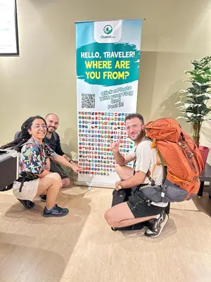 a group of people sitting on the floor next to a sign at A3A Oastel CoLiving in Tanah Rata