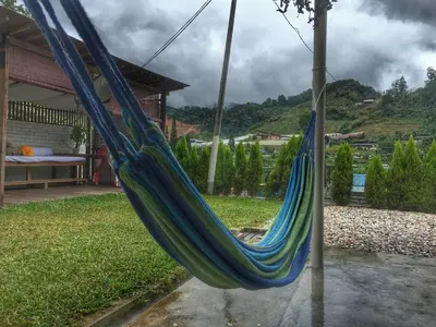 a blue hammock hanging from a pole in a yard at Tung's Factoria Cameron Highland in Cameron Highlands