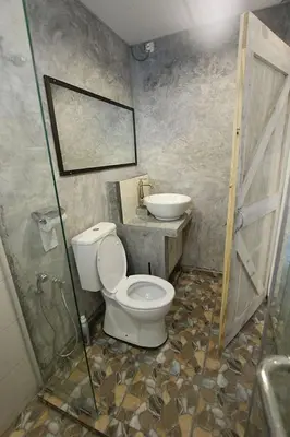 a bathroom with a toilet and a sink at Tung's Factoria Cameron Highland in Cameron Highlands