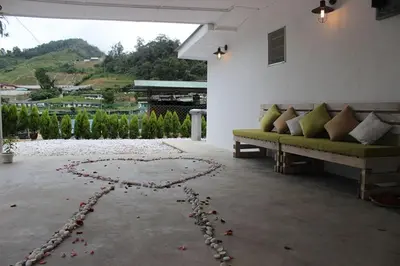 a room with a couch and a heart on the ground at Tung's Factoria Cameron Highland in Cameron Highlands