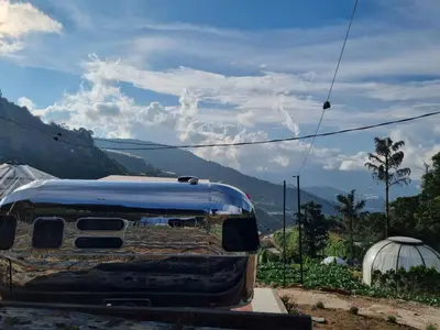 a van parked on the side of a mountain at A'moss Farmstay in Cameron Highlands