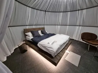a bedroom with a bed in a tent at A'moss Farmstay in Cameron Highlands