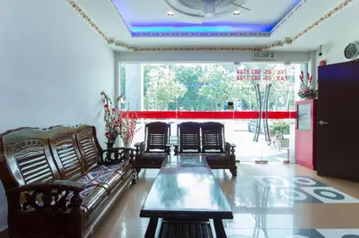 a living room with couches and a table in front of a window at Valley View Hotel in Lumut