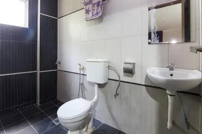 a bathroom with a toilet and a sink at Valley View Hotel in Lumut