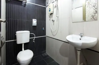 a bathroom with a toilet and a sink at Valley View Hotel in Lumut