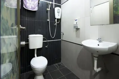 a bathroom with a toilet and a sink at Valley View Hotel in Lumut