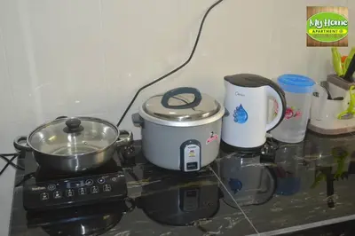 a counter top with a stove with a pot on it at My Homestay N16 (14 pax) @ Golden Hills Night Market in Brinchang