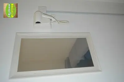 a mirror on a wall with a light on it at My Homestay N16 (14 pax) @ Golden Hills Night Market in Brinchang