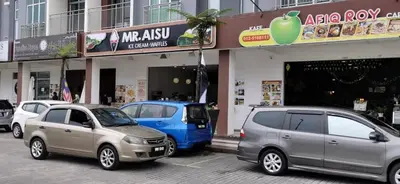 a group of cars parked in front of a building at My Homestay N16 (14 pax) @ Golden Hills Night Market in Brinchang