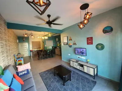 a living room with a couch and a ceiling fan at Cameron Mossy Home @ Quintet in Tanah Rata