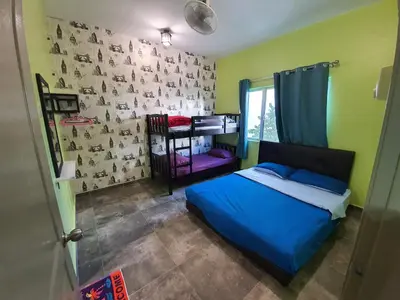 a bedroom with a bed and a wall with animals on it at Cameron Mossy Home @ Quintet in Tanah Rata