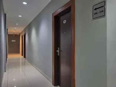 a hallway with a door in a building at Anggerik Garden Hotel - AG Hotel in Sitiawan