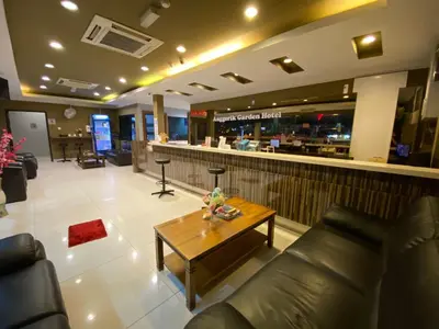 a lobby with a coffee table and a bar at Anggerik Garden Hotel - AG Hotel in Sitiawan