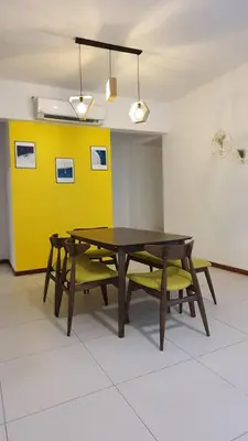 a dining room with a table and two yellow chairs at The Landmark by Katana 4BR Luxury Seaview Homestay Gurney\u65e0\u654c\u6d77\u666f\u56db\u623f\u5957\u623f in Tanjong Tokong
