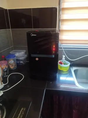 a microwave sitting on top of a kitchen counter at Nurul Homestay in Kepala Batas