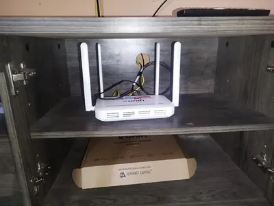 a router sitting on top of a box on a shelf at Nurul Homestay in Kepala Batas