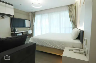 a hotel room with a bed and a television at Legacy Hotel Ipoh in Ipoh