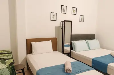 a small room with two beds and a mirror at 3133 Heritage Home in George Town
