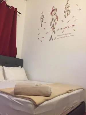 a bed with a blanket on it in a room at 3133 Heritage Home in George Town