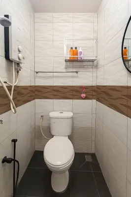 a bathroom with a white toilet in a room at 3133 Heritage Home in George Town