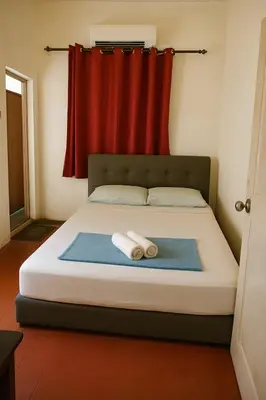 a bedroom with a bed with two towels on it at 3133 Heritage Home in George Town