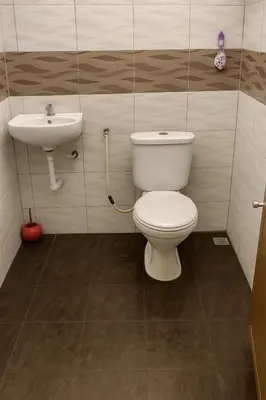 a bathroom with a toilet and a sink at 3133 Heritage Home in George Town