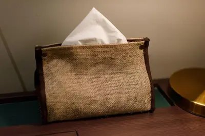 a brown bag with a white tissue sitting on a table at Sojourn Spa Hotel Ipoh in Ipoh