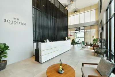 a lobby with a reception desk in a building at Sojourn Spa Hotel Ipoh in Ipoh
